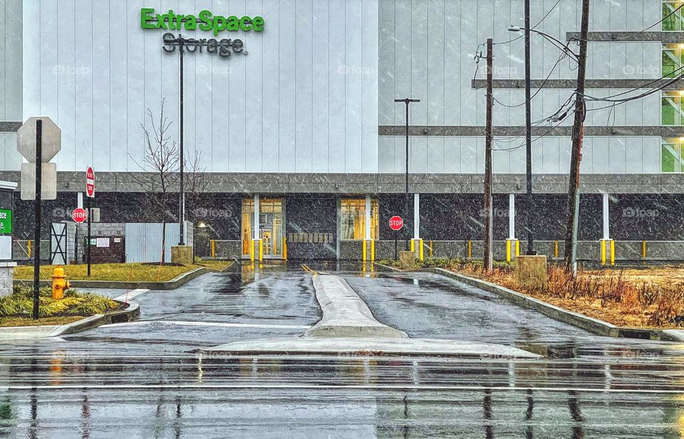 Snowing outside a storage facility in New England 