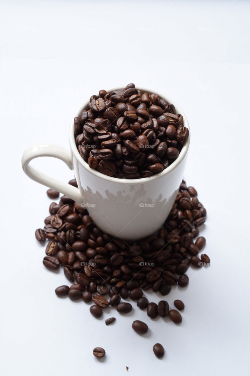 Roasted coffee beans against white background