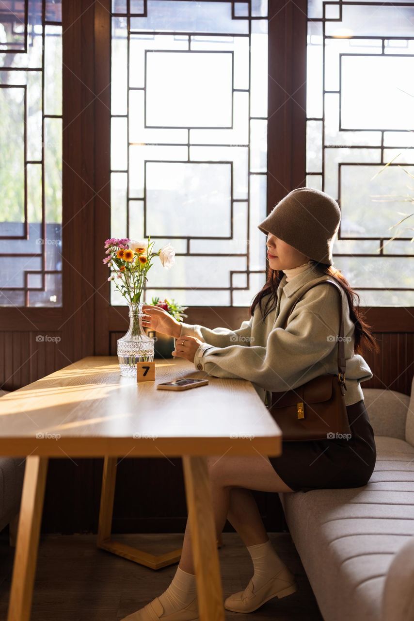 Stylish woman relaxing in cafe near window 