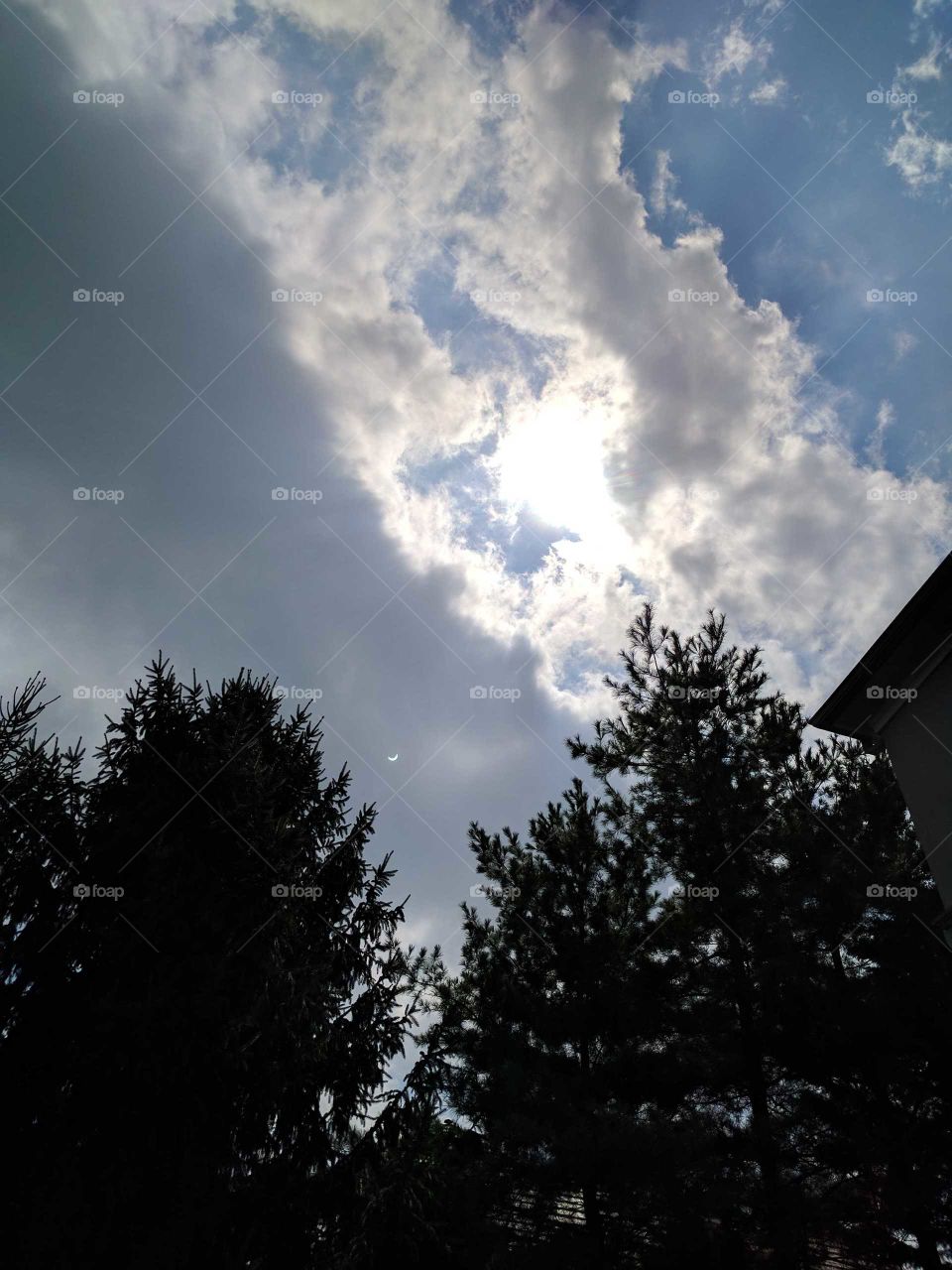 solar eclipse behind the clouds