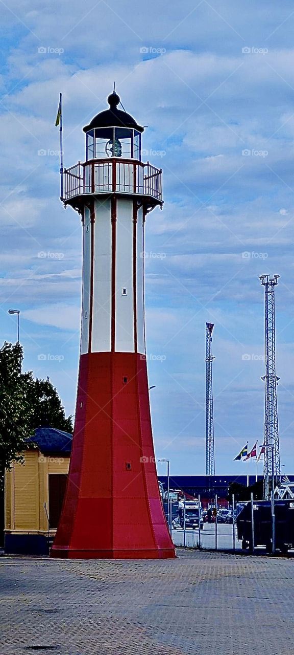 This is an antique lighthouse in the traditional red and white colors by the “Baltic Sea” in the city of “Ystad” in “Sweden”, “Scandinavia”. 2023. Hypnotic Productions