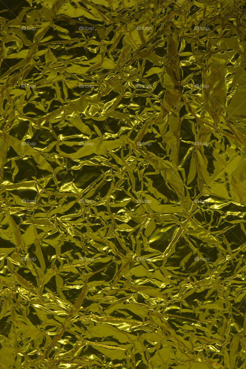 Crumpled gold paper texture background