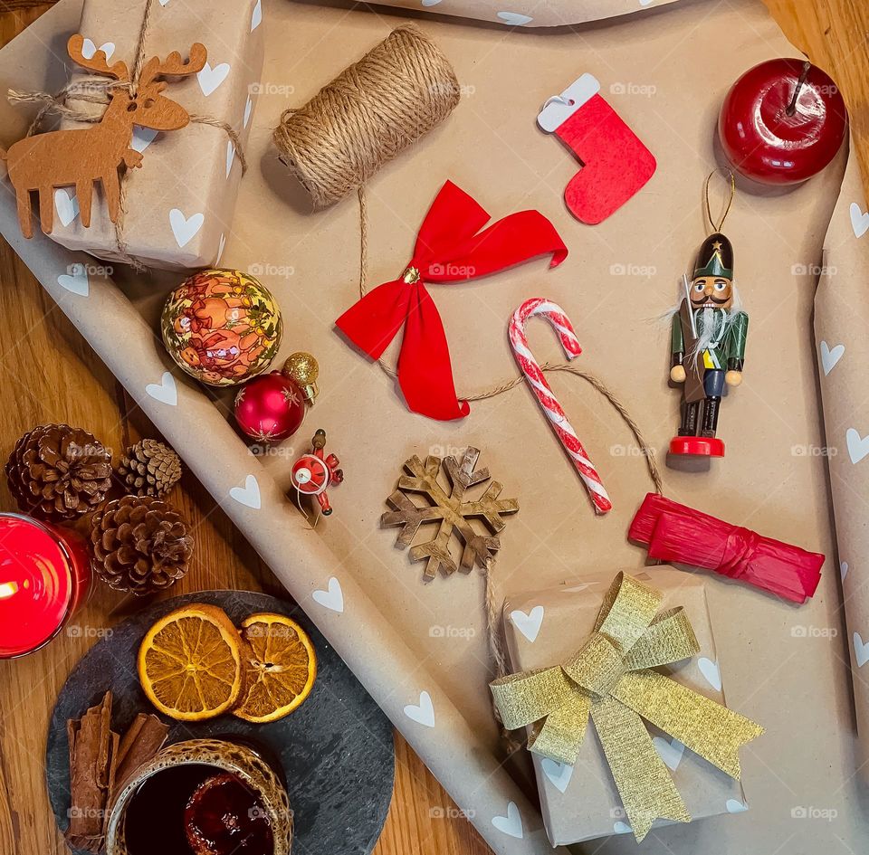 Flat lay of wrapping gifts with mulled wine and festive accessories 