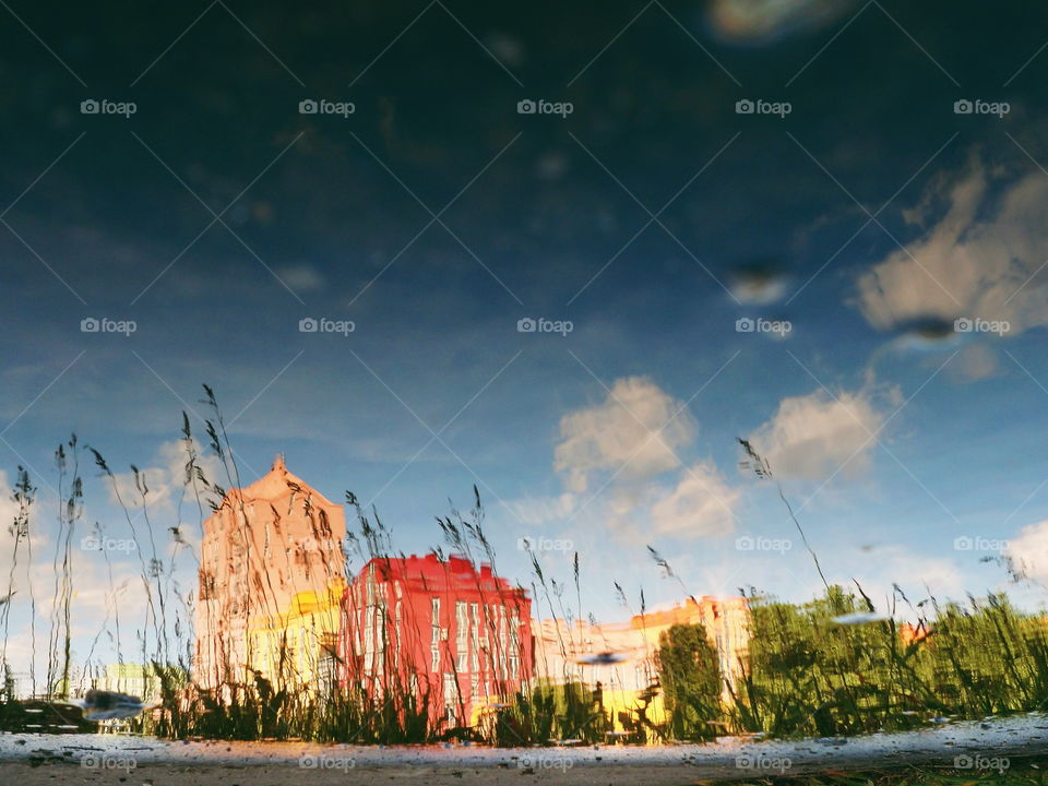 Reflection of a building in a puddle