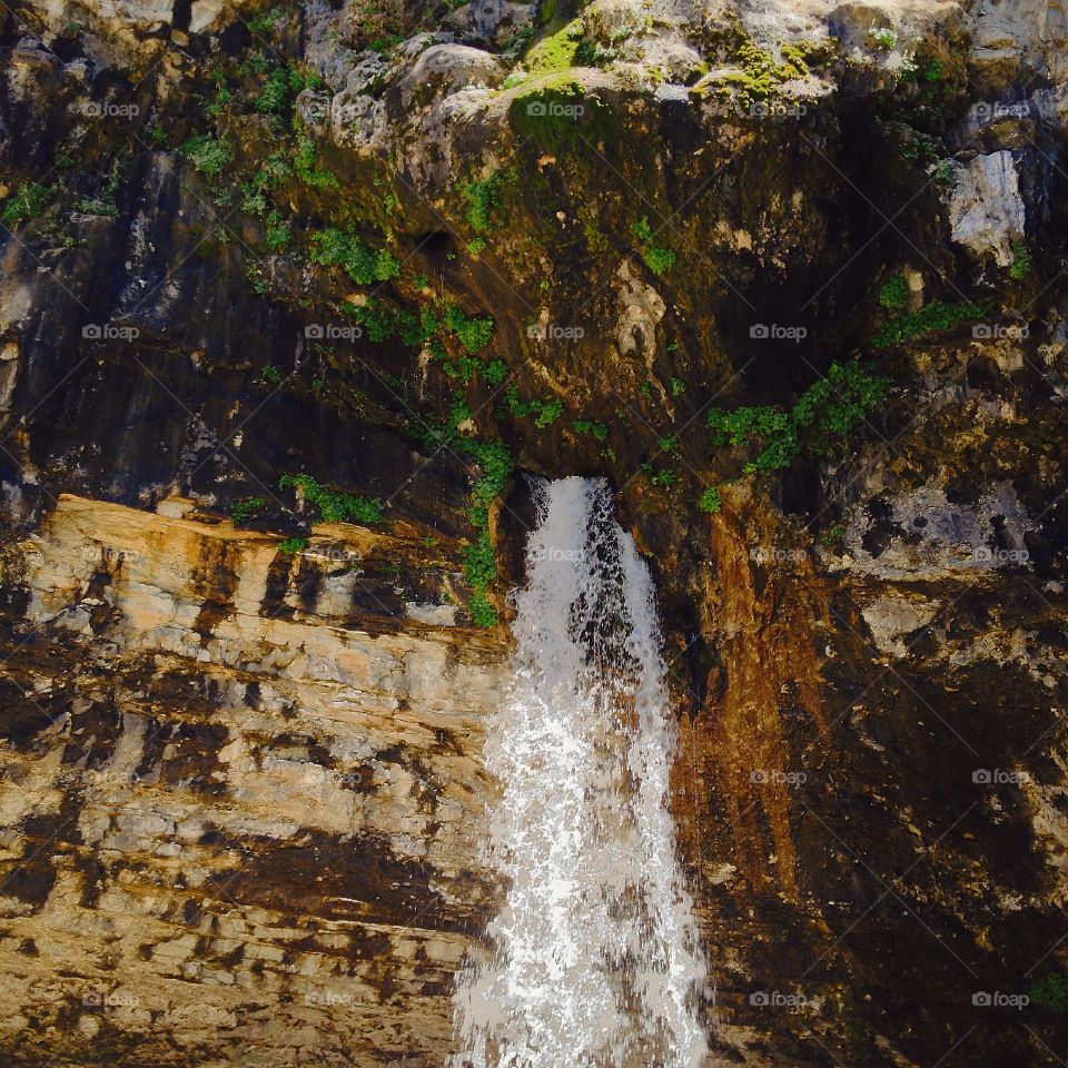 Water falling through boulder 
