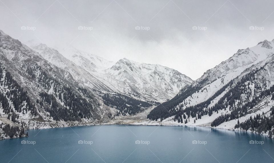 I forgot cold for a while... Snow mountain , Pine forest,  Water stream Beautiful blue lake at big Almaty lake in Kazakhstan