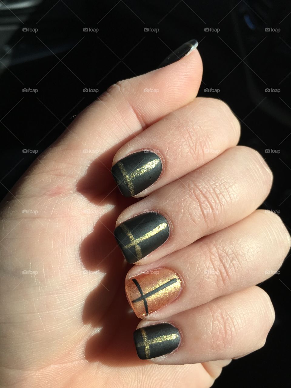 Ladies hand with black and gold Celtic pattern