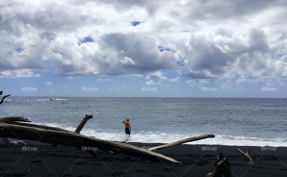 Enjoying the surf at the black sand beach