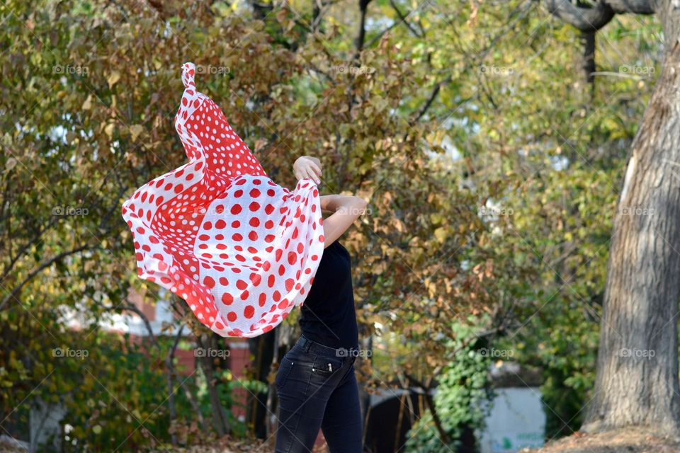 Beautiful Young Woman Dancing with Scarf Outside in Nature