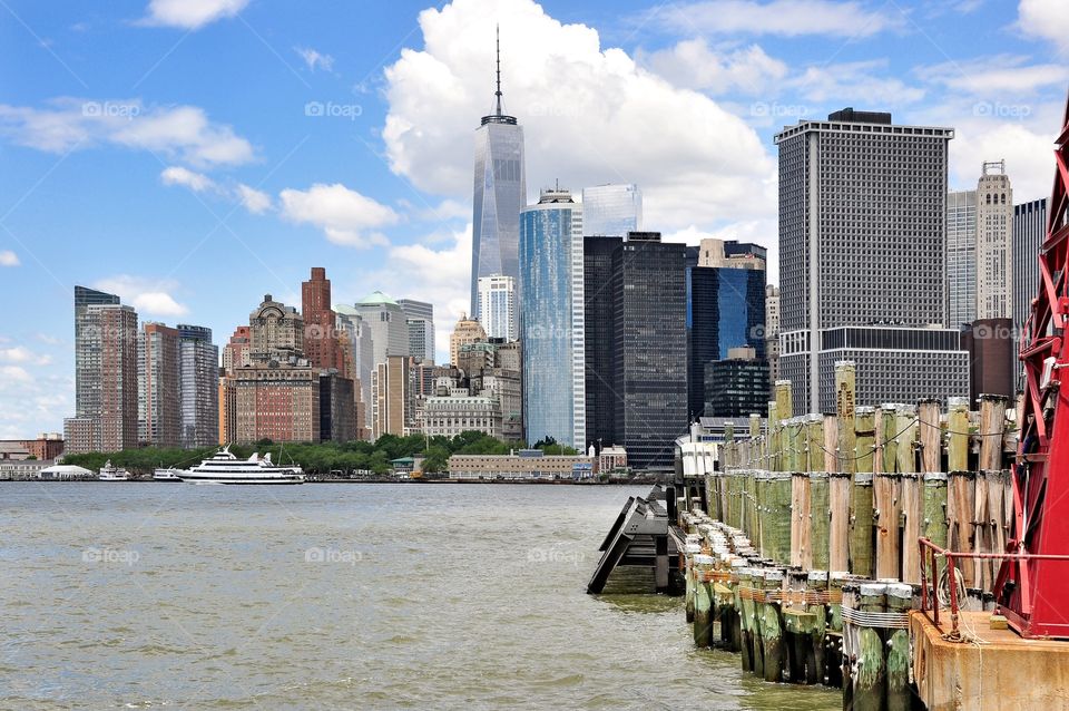 Freedom Tower . Freedom Tower from Governor's Island. Beautiful skyline of lower Manhattan with new and older skyscrapers and river view