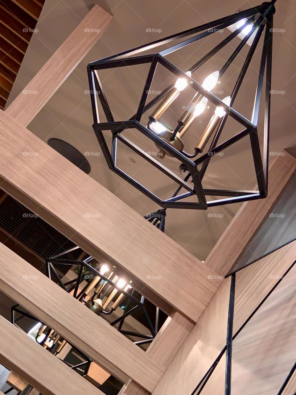 Lights on hexagonal design and triangular wood wall inside the Restaurant New York. 