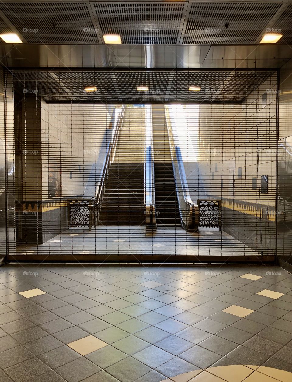 A gate is pulled down, closing a Metro Station exit (reduced service schedules due to Pandemic) in Los Angeles CA 6.12.2020