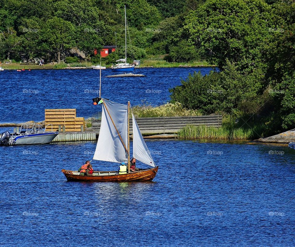 Sailboat approaching harbour