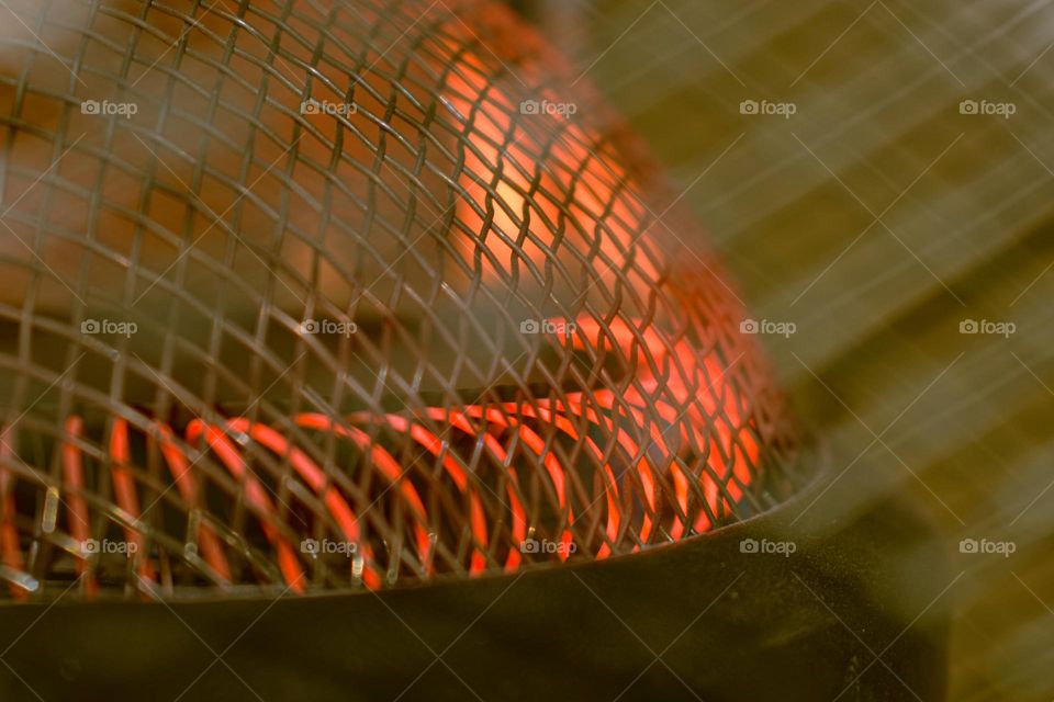 hot red metal coil and mesh with bokeh lines foreground