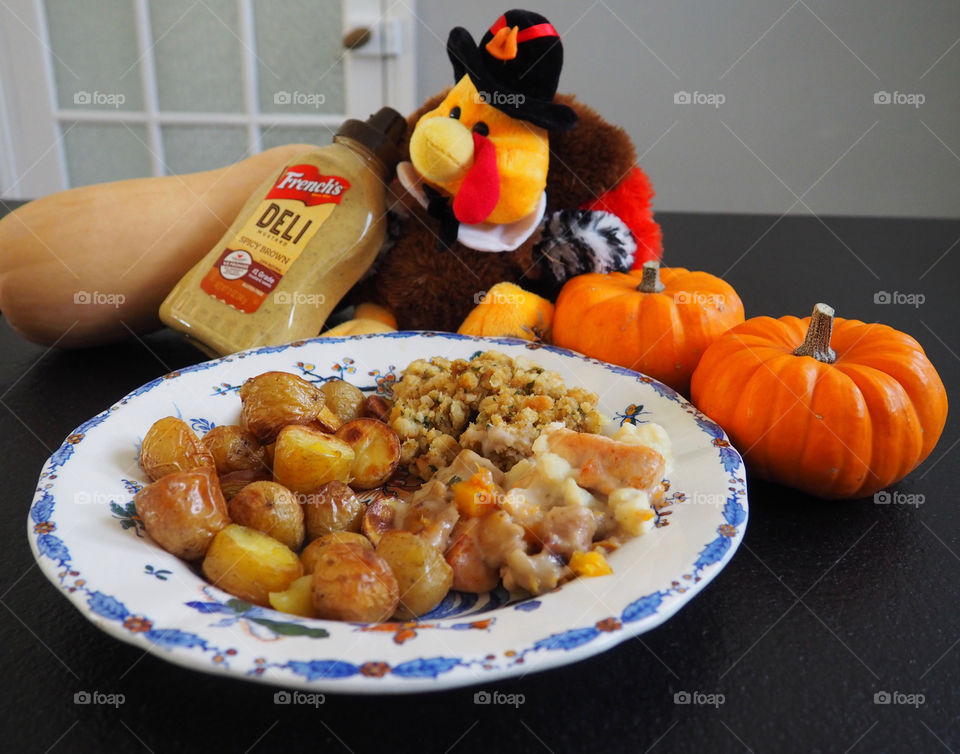 Thanksgiving plate of turkey in a creamy French’s deli mustard sauce with stuffing and roasted potatoes.