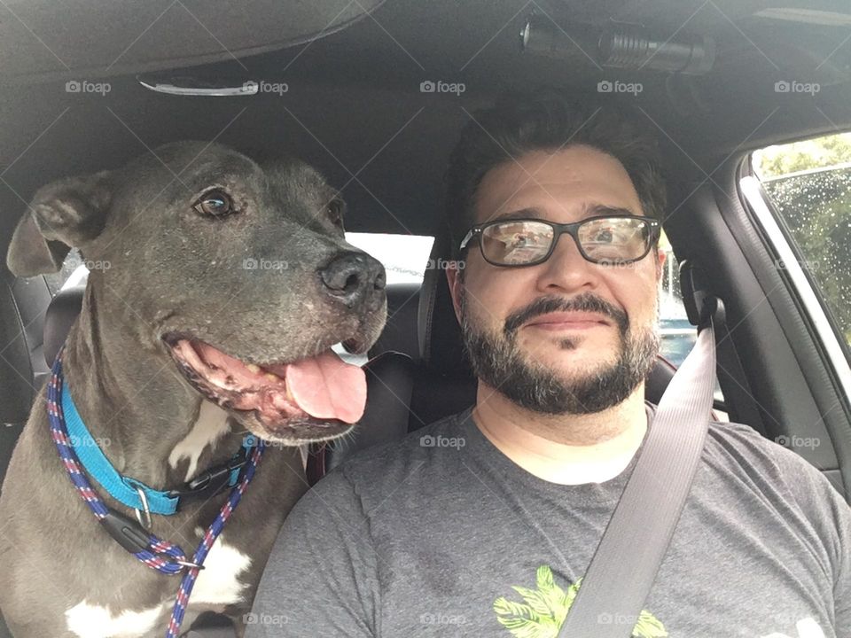 Man smiling with his beautiful rescue pitbull dog