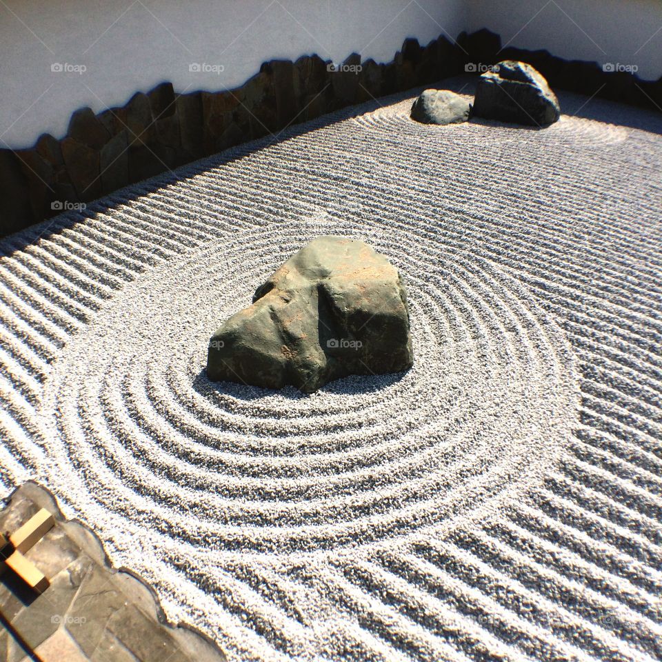 Rock with swirled sand in a zen garden 