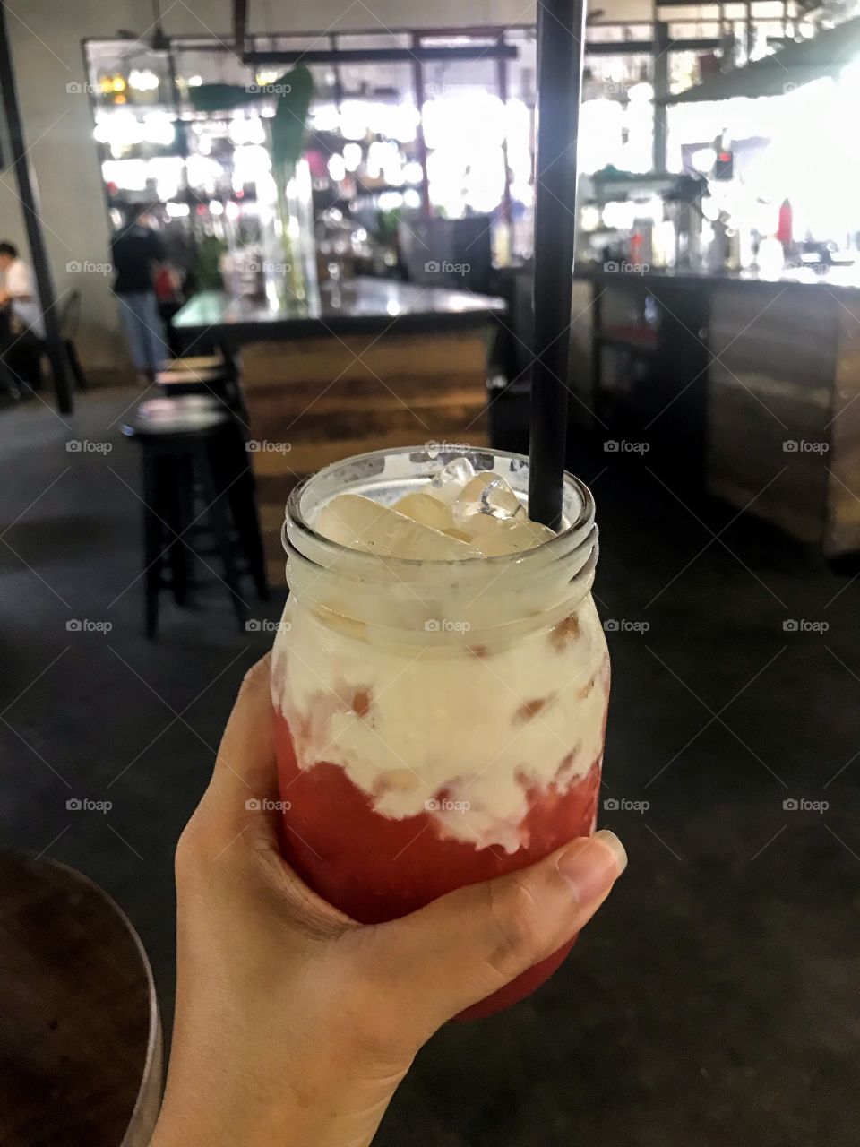 A glass of tea with pink grapefruit and red guava, Cheese form and ice cubes, sweet and sour.  It's great to drink in hot weather