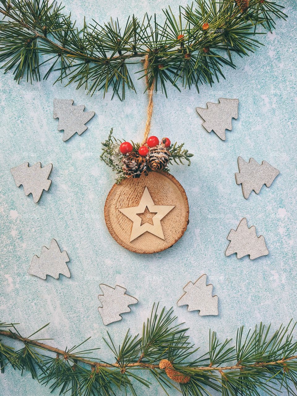 Christmas or New Year composition.  Fir branches with festive decor on a light blue background. Top view. Flat lay.