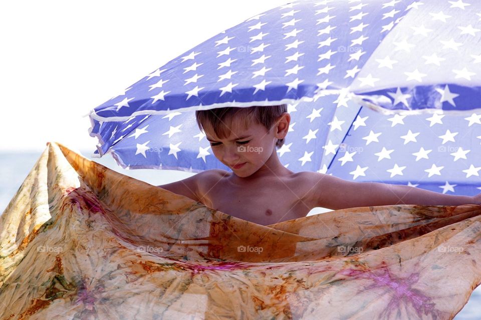 Kid under umbrella