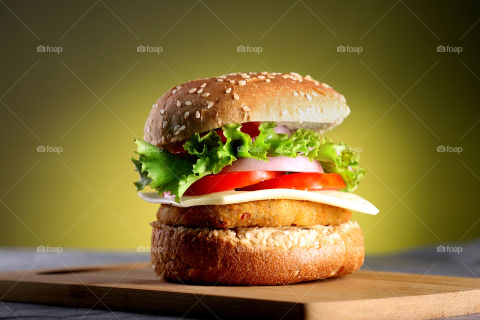 Fast food burger with yellow background