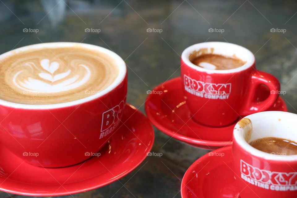 Red cups with coffee on tabletop