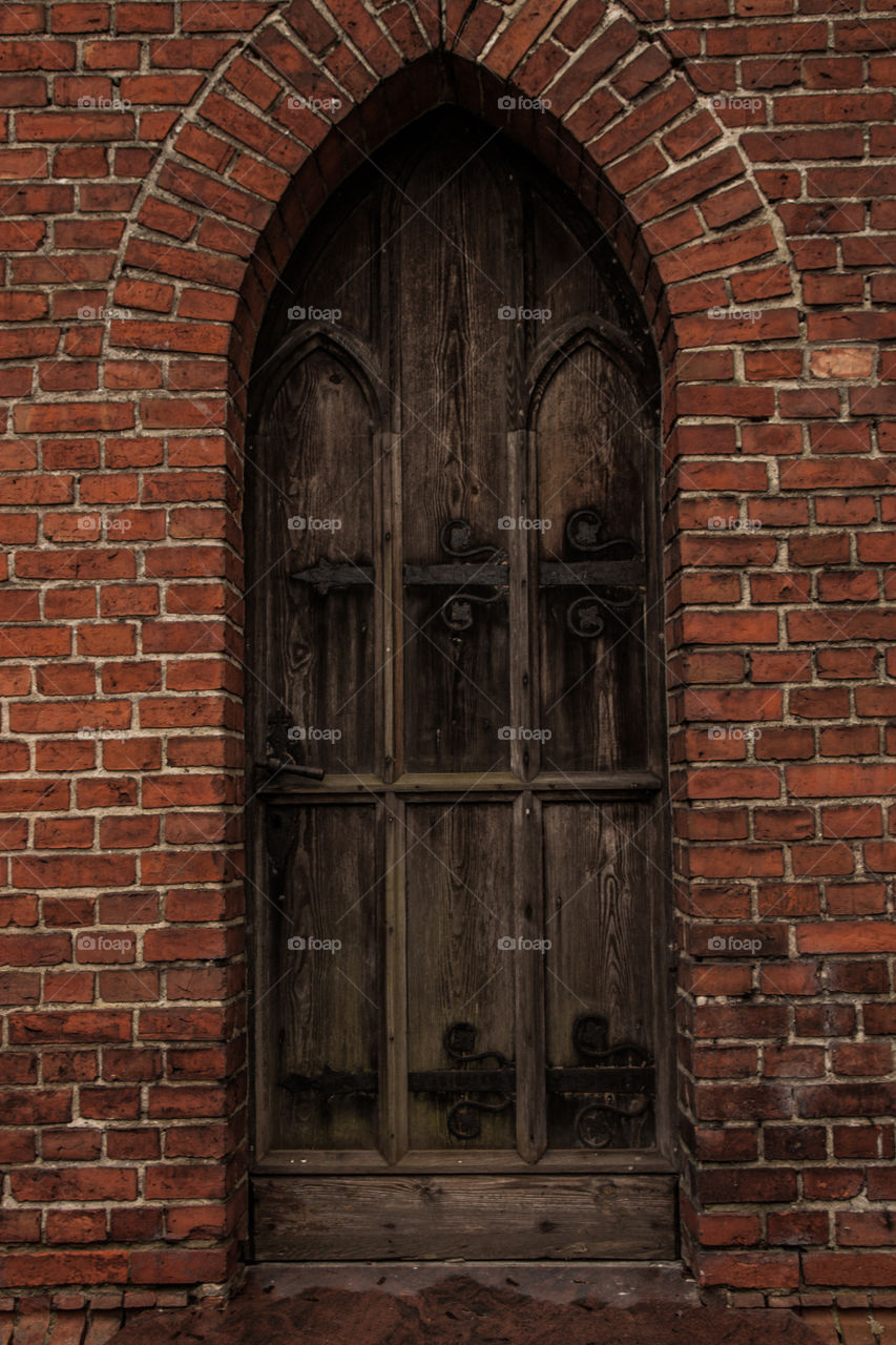 Old door. Wooden old door in the brick wall