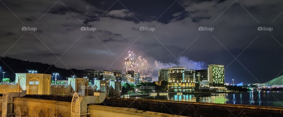 Seeing Double through the reflection on beautiful new year night of cityscape in the middle of river flows is such a fascinating experience at Kualalumpur City of Malaysia Landscape Beauty.