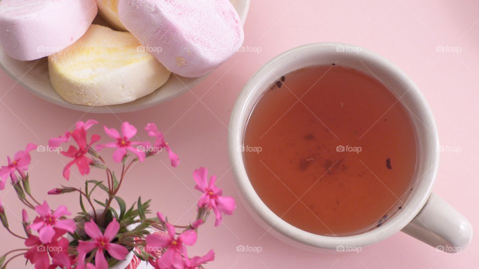 Tea in tea cup with sweet food