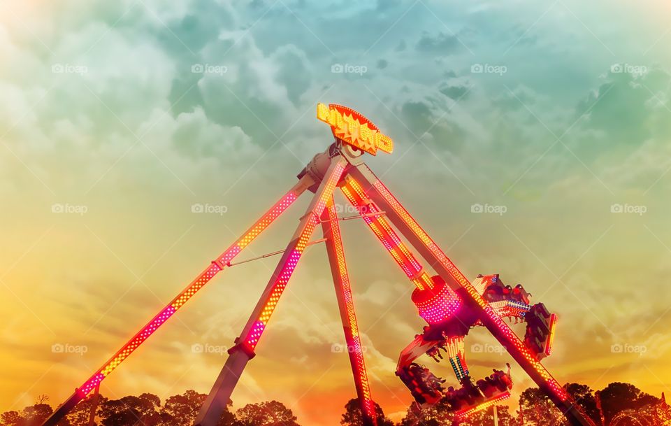 Joyride at the carnival as the sun sets in vivid colors.