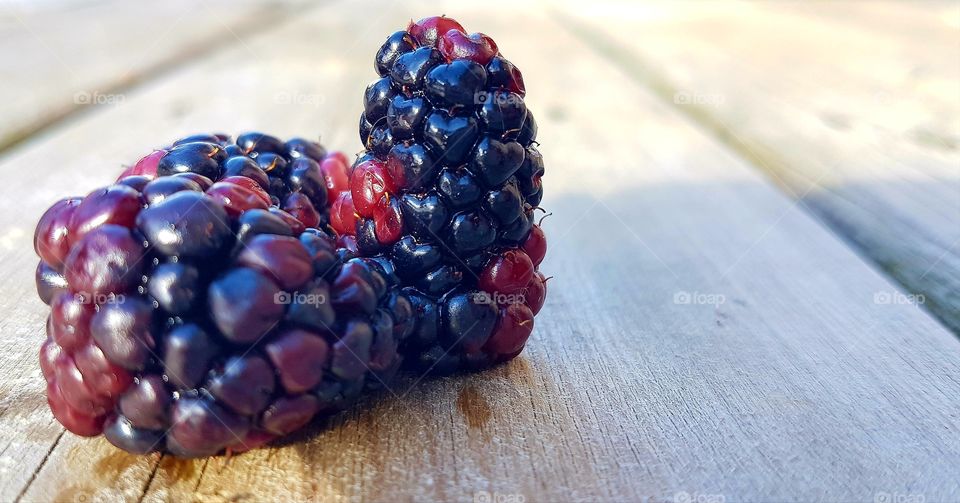 Red and blueberries on wood