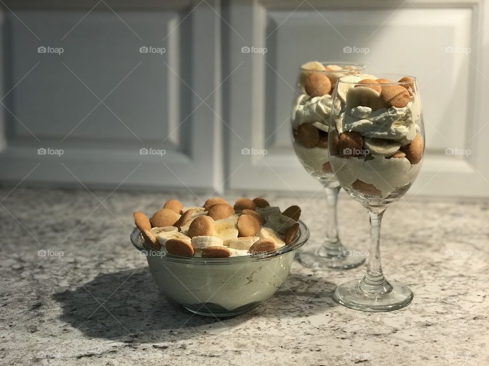 Homemade banana pudding in glasses and bowl