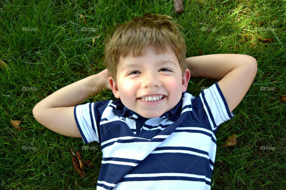 Small kid lying on grass