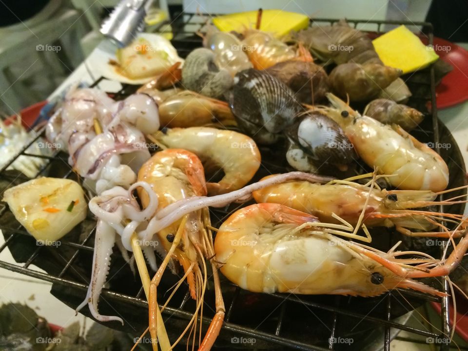 Street food seafood grilled on stove 