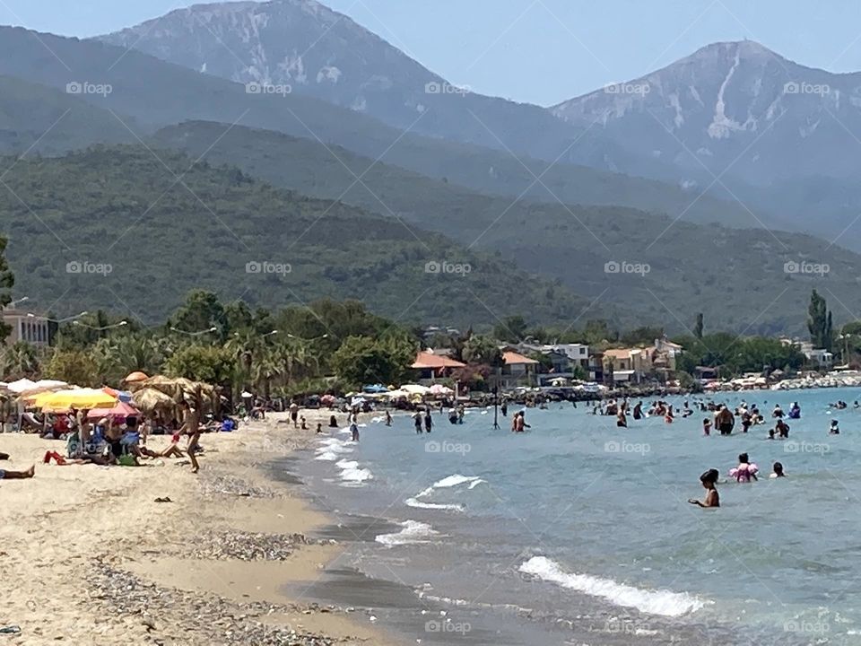 Sunny holidays I’m Turkey. Walk in the cute city and charming streets by the beach in Kusadasi. perfect blue sky and ocean view. Beach and the shore. To travel is to live. Gorgeous tall palm trees.