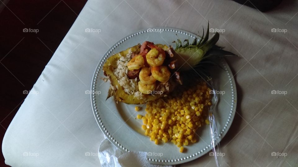 "Pineapple Plate"- a romantic homemade dinner consisting of split shaved pineapple, stuffed with rice, polish sausage, tuna steak slices, and grilled shrimp. Whole kernel corn as a side