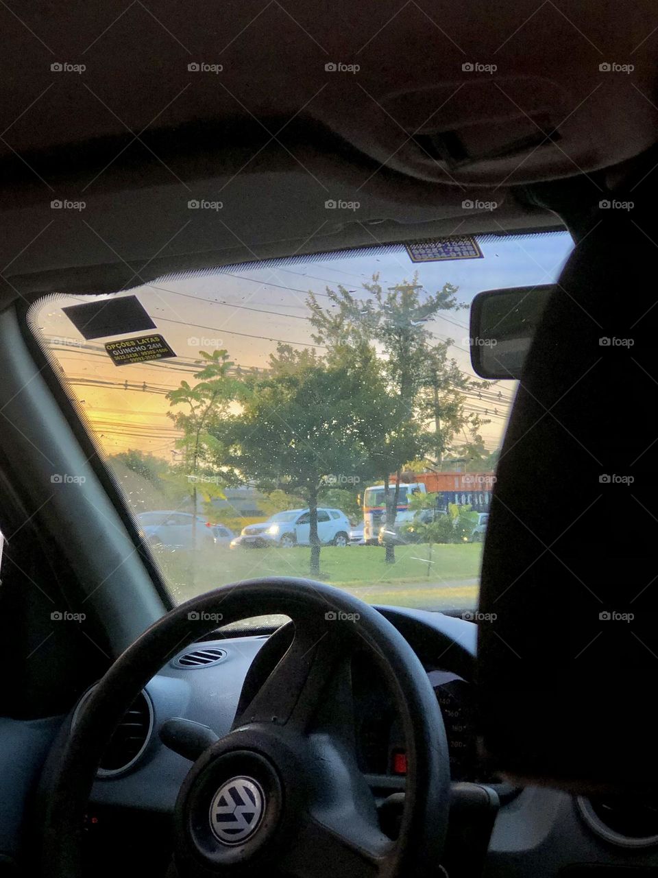 "As morning traffic crawls, the landscape beyond the car window transforms into a scene of serenity, where golden sunbeams caress the slumbering buildings, painting the dawn with promises of a new day. 🌇🚗✨"