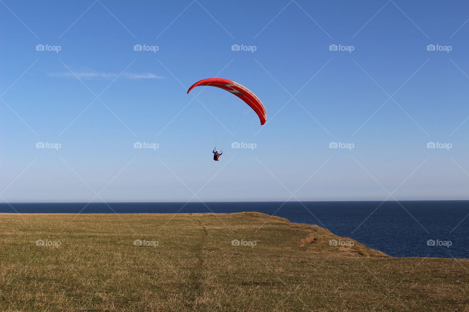 Paraglider by the coast at Kåseberga, Sweden.