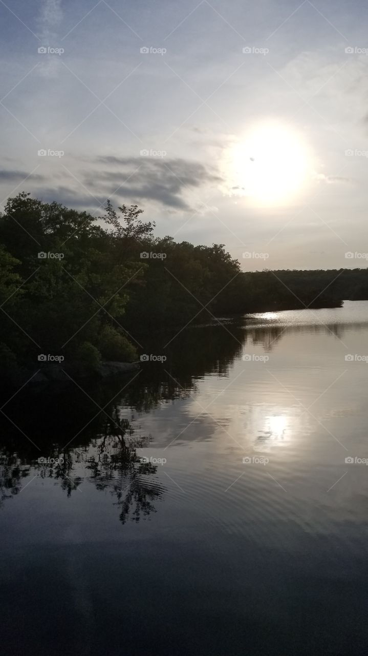 Sunset over still water
