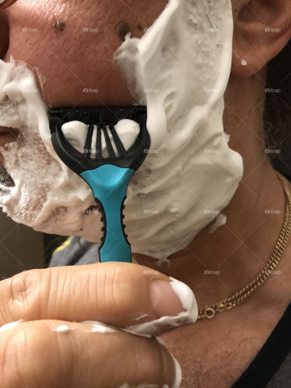 shaving with face foam close up