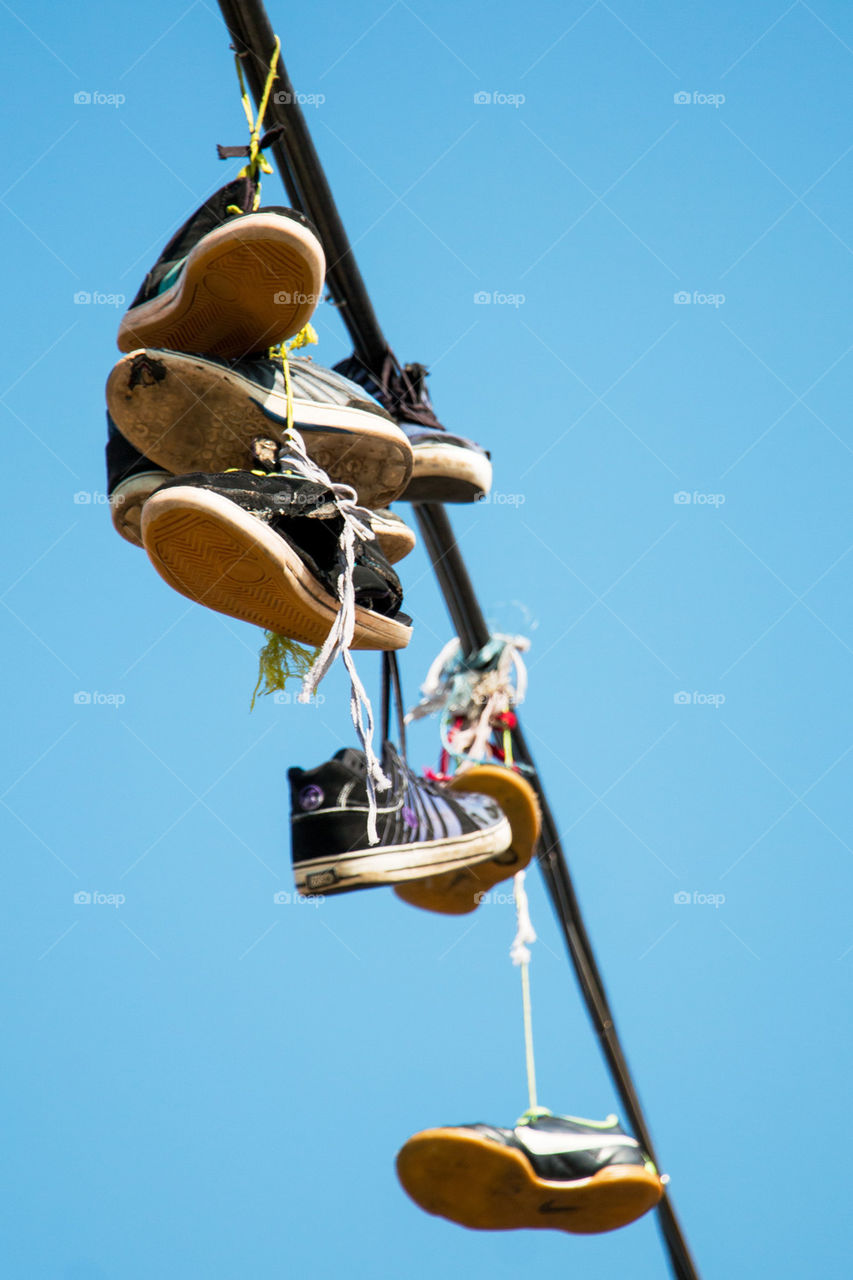 Shoes hanging from a wire