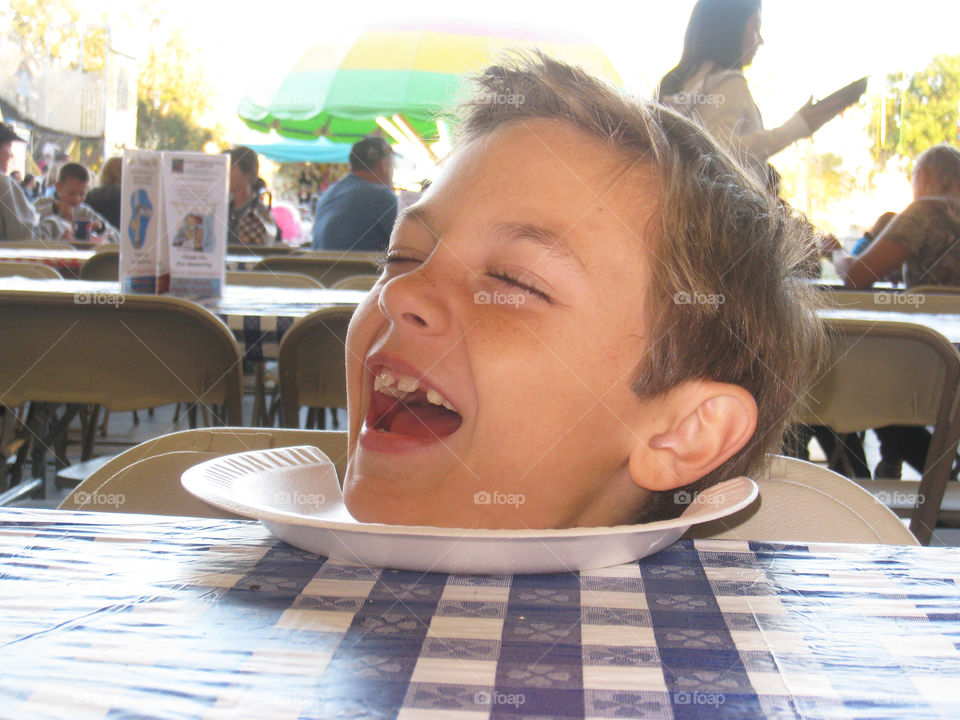 Boy sitting on table