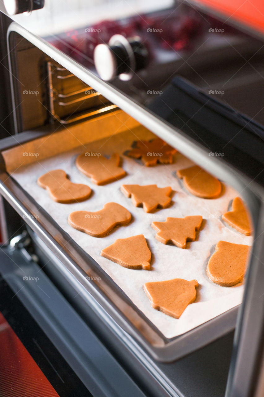 Process of baking homemade gingerbread Christmas cookies in oven 