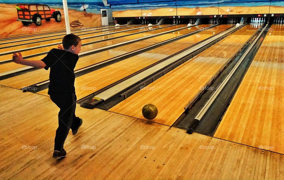 Young boy at bowling alley