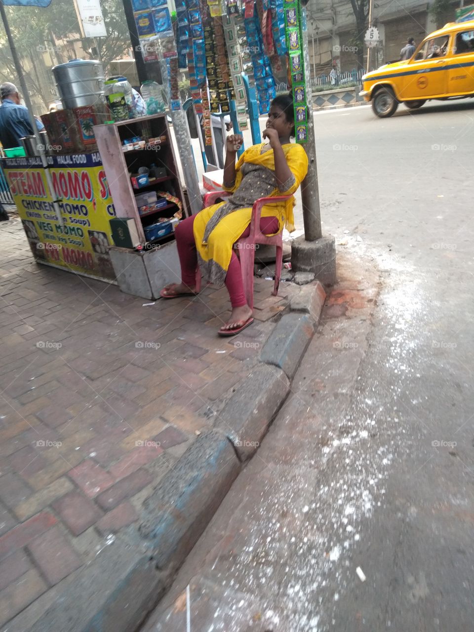 No buyer for this pavement seller girl. Kolkata economics is down down and down