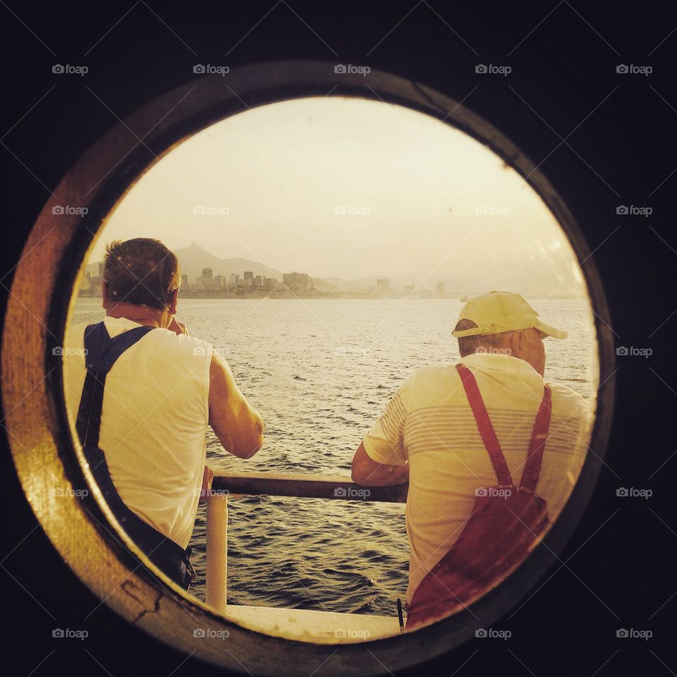I work on an expedition ship, so my commute is different than most. These two sailors enjoy the sunshine outside while we wait for customs officials to board along the coast of Rio de Janeiro, Brazil.