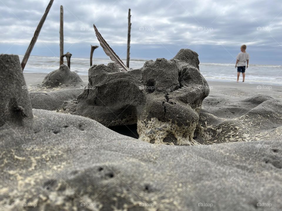 Sandcastle ruined by the tide