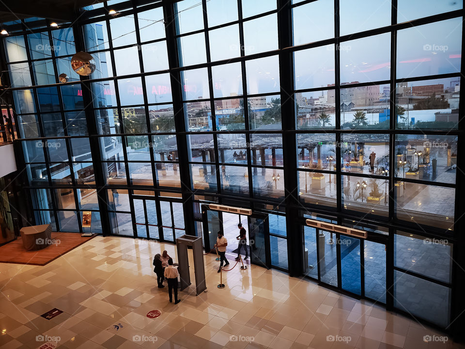 People coming through the main gate of the big mall.