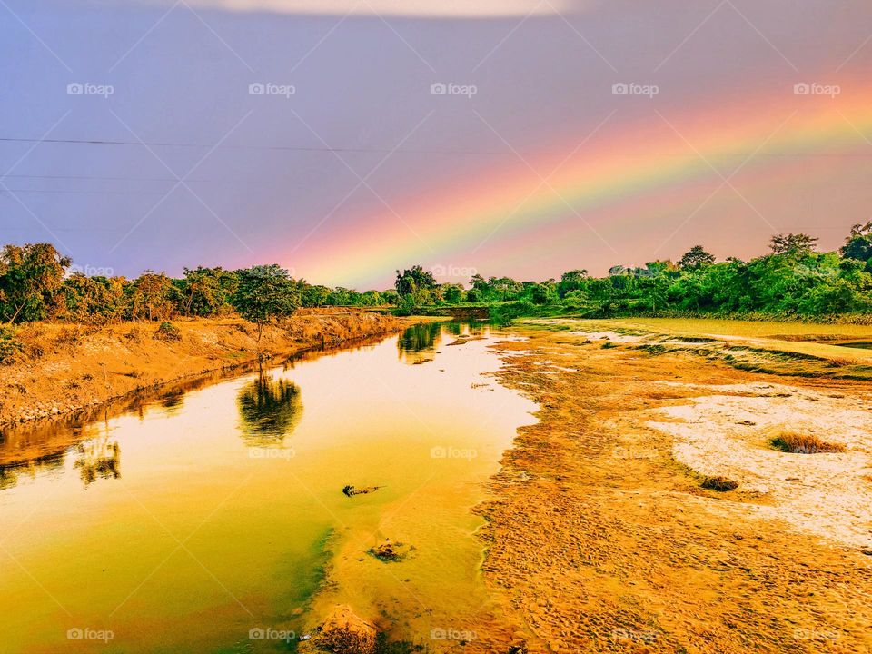 I have a picture of this river a little away from our house.  The rainbow rose across the river.  Looks very nice.