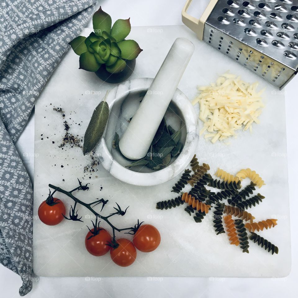 Flatlay .. marble chopping board with ingredients for pasta dish 